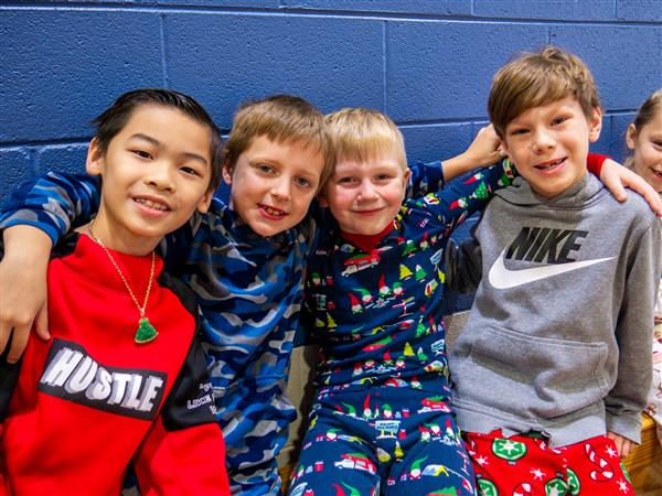 Students in holiday clothes doing festive things at school. 